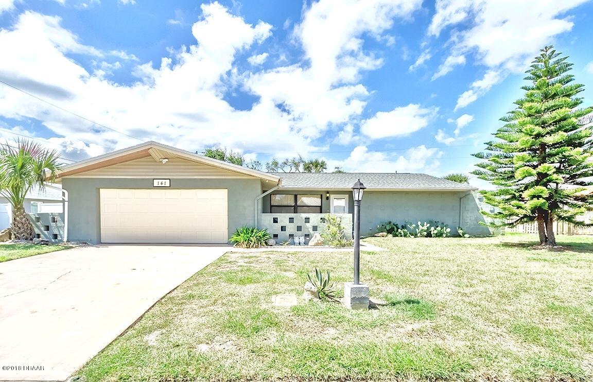 141 Beau Rivage Drive Ormond Beach, FL 32176 - Photo 1 of 34 a front view of a house with a yard and garage