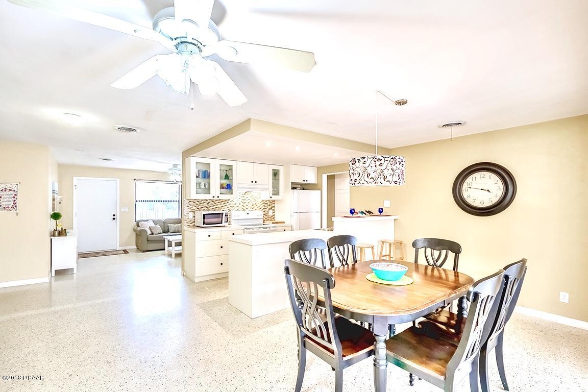 141 Beau Rivage Drive Ormond Beach, FL 32176 - Photo 11 of 34 a view of a dining room and livingroom with furniture wooden floor and a chandelier