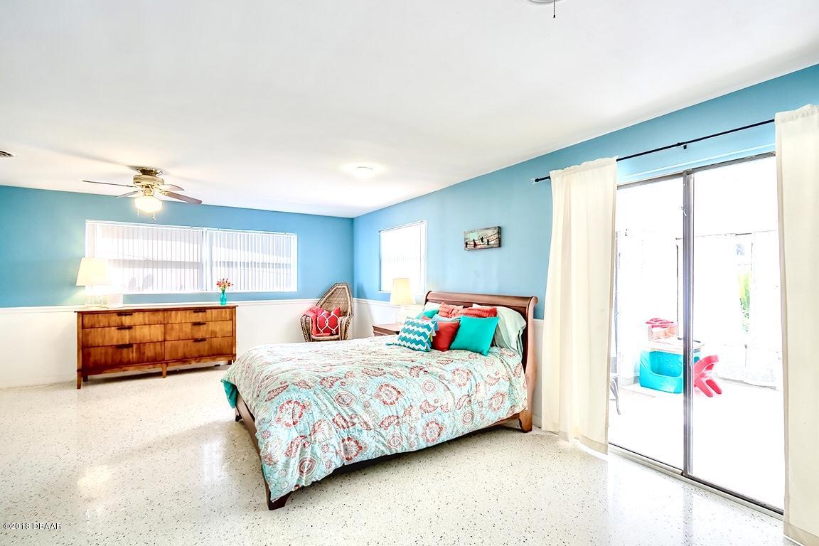 141 Beau Rivage Drive Ormond Beach, FL 32176 - Photo 13 of 34 a bedroom with a bed and window