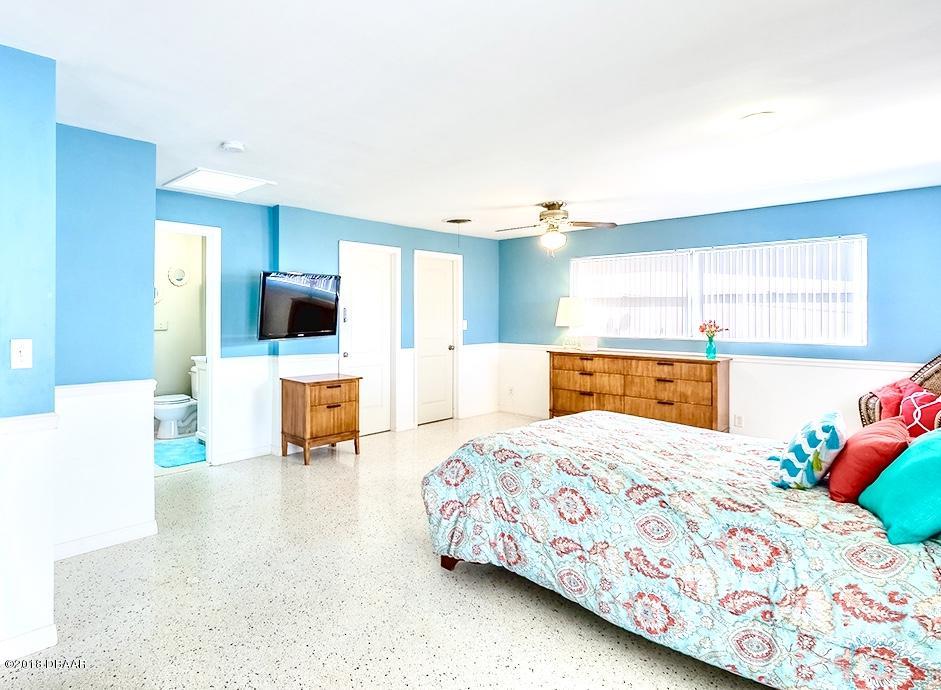 141 Beau Rivage Drive Ormond Beach, FL 32176 - Photo 14 of 34 a bedroom with a bed and a view of kitchen