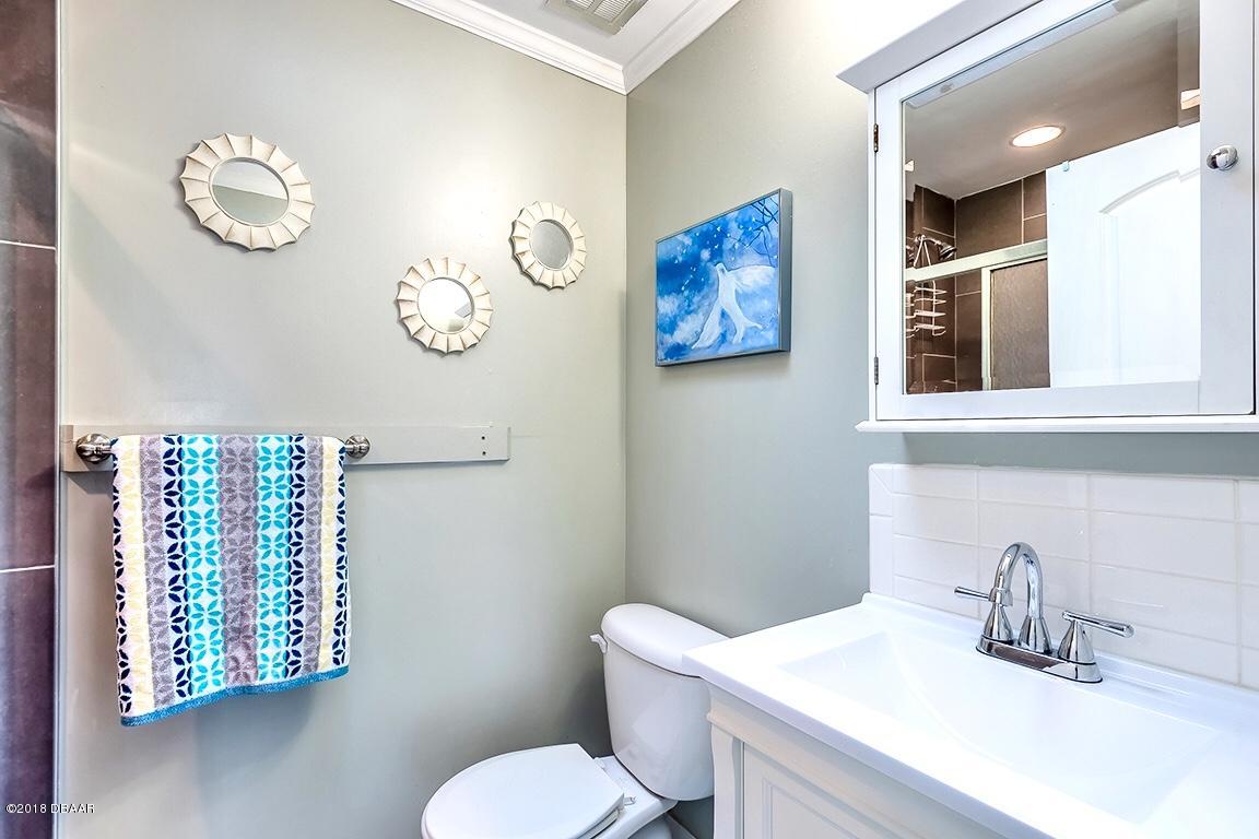141 Beau Rivage Drive Ormond Beach, FL 32176 - Photo 15 of 34 a bathroom with a toilet sink and mirror