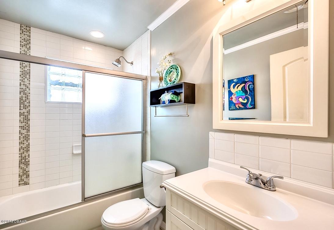 141 Beau Rivage Drive Ormond Beach, FL 32176 - Photo 17 of 34 a white toilet sitting next to a bathroom sink