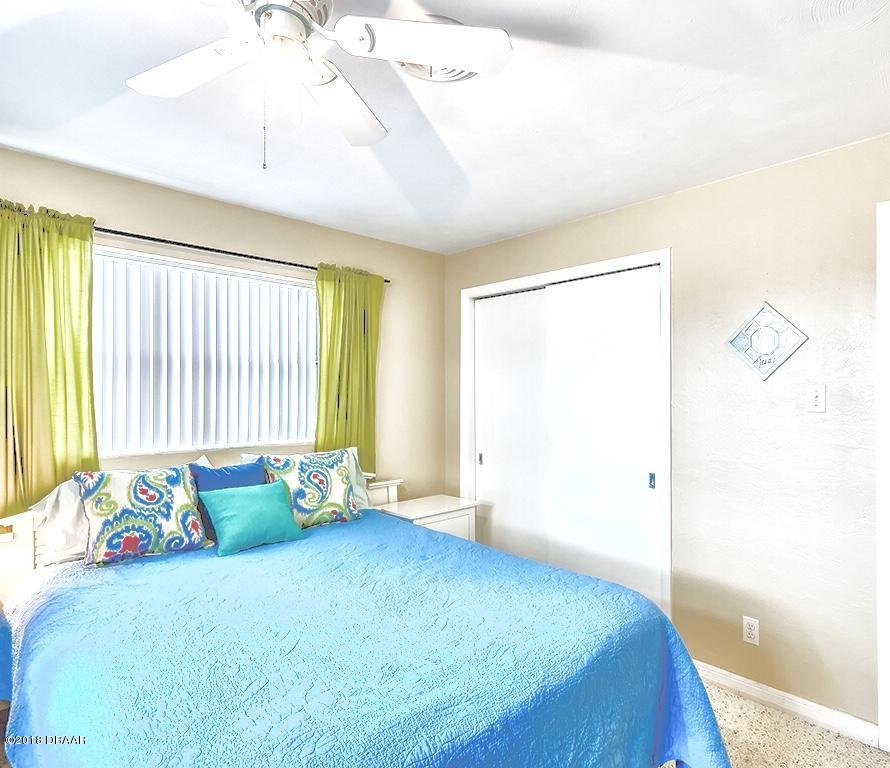 141 Beau Rivage Drive Ormond Beach, FL 32176 - Photo 19 of 34 a bedroom with a bed and a window
