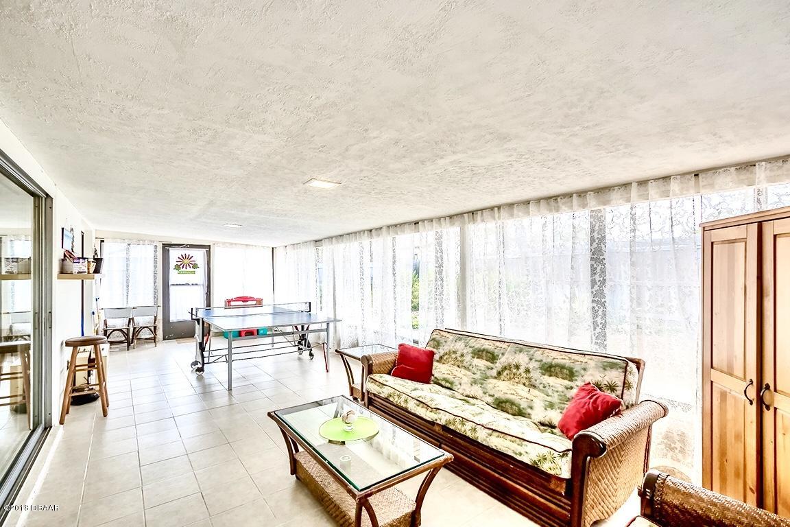 141 Beau Rivage Drive Ormond Beach, FL 32176 - Photo 20 of 34 a living room with furniture and a large window