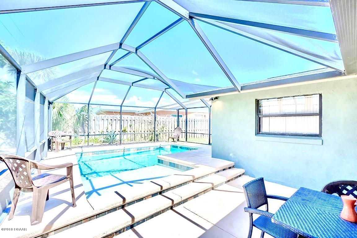141 Beau Rivage Drive Ormond Beach, FL 32176 - Photo 23 of 34 a bedroom with a bed and a table