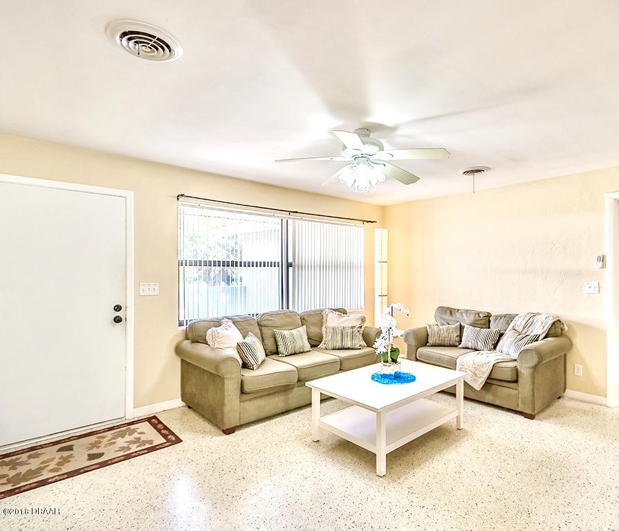 141 Beau Rivage Drive Ormond Beach, FL 32176 - Photo 4 of 34 a living room with furniture and a large window