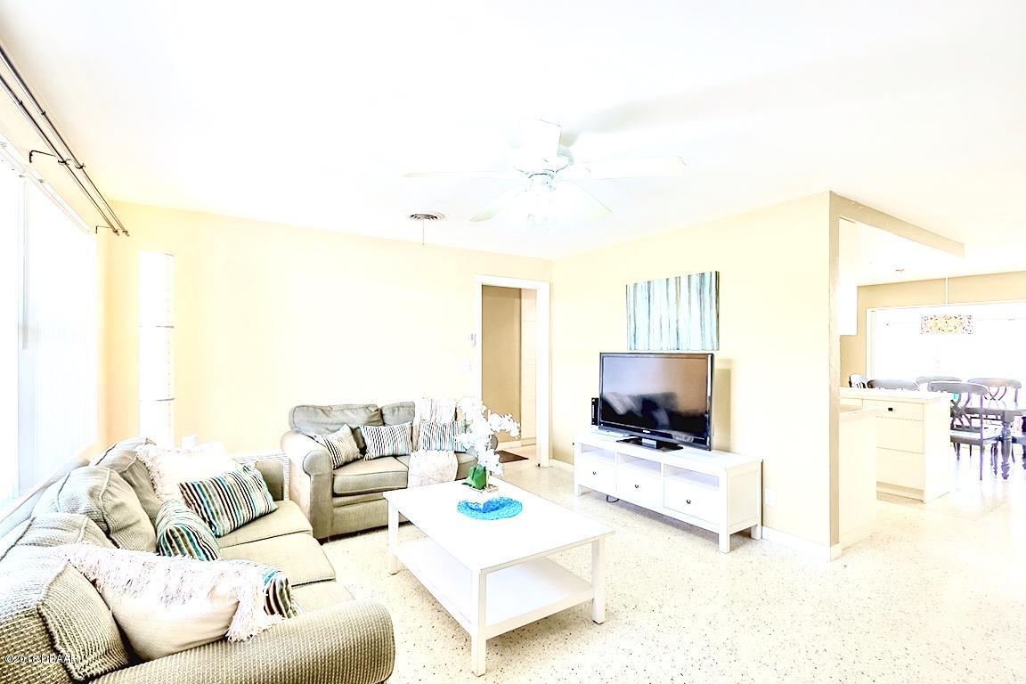 141 Beau Rivage Drive Ormond Beach, FL 32176 - Photo 5 of 34 a living room with furniture and a flat screen tv