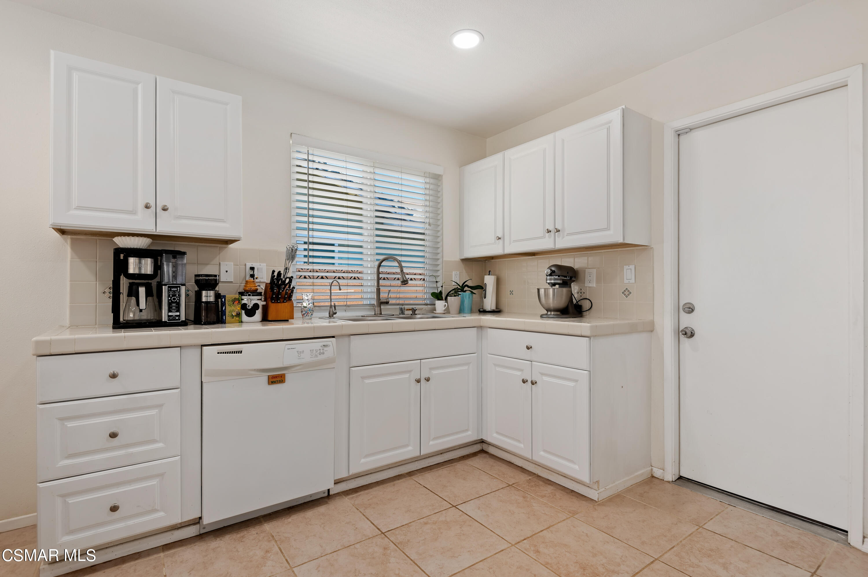 1714 Fitzgerald Road Simi Valley, CA 93065 - Photo 11 of 23 a kitchen with white cabinets and white appliances