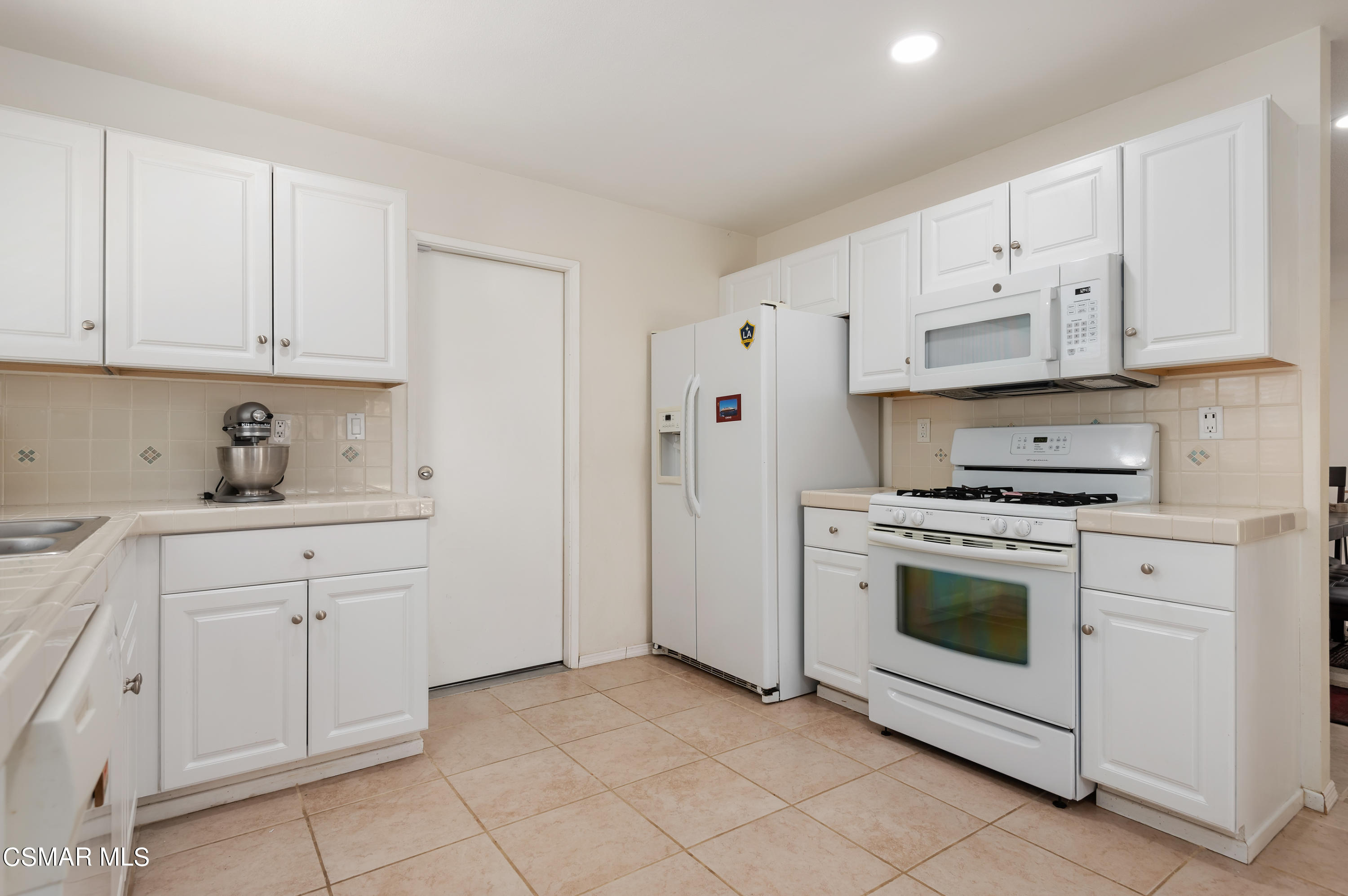 1714 Fitzgerald Road Simi Valley, CA 93065 - Photo 12 of 23 a kitchen with white cabinets and white appliances