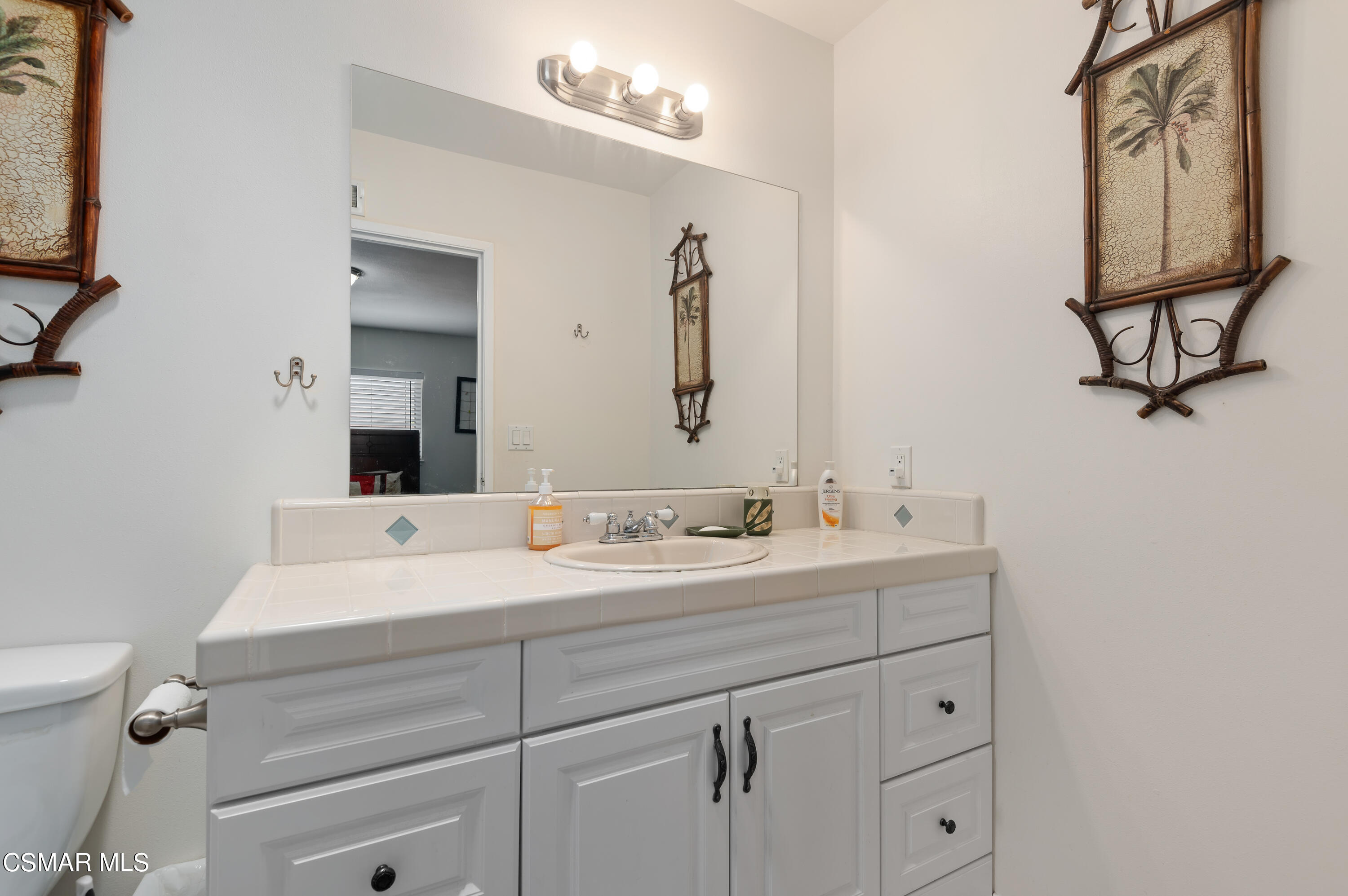 1714 Fitzgerald Road Simi Valley, CA 93065 - Photo 15 of 23 a bathroom with a sink and a mirror