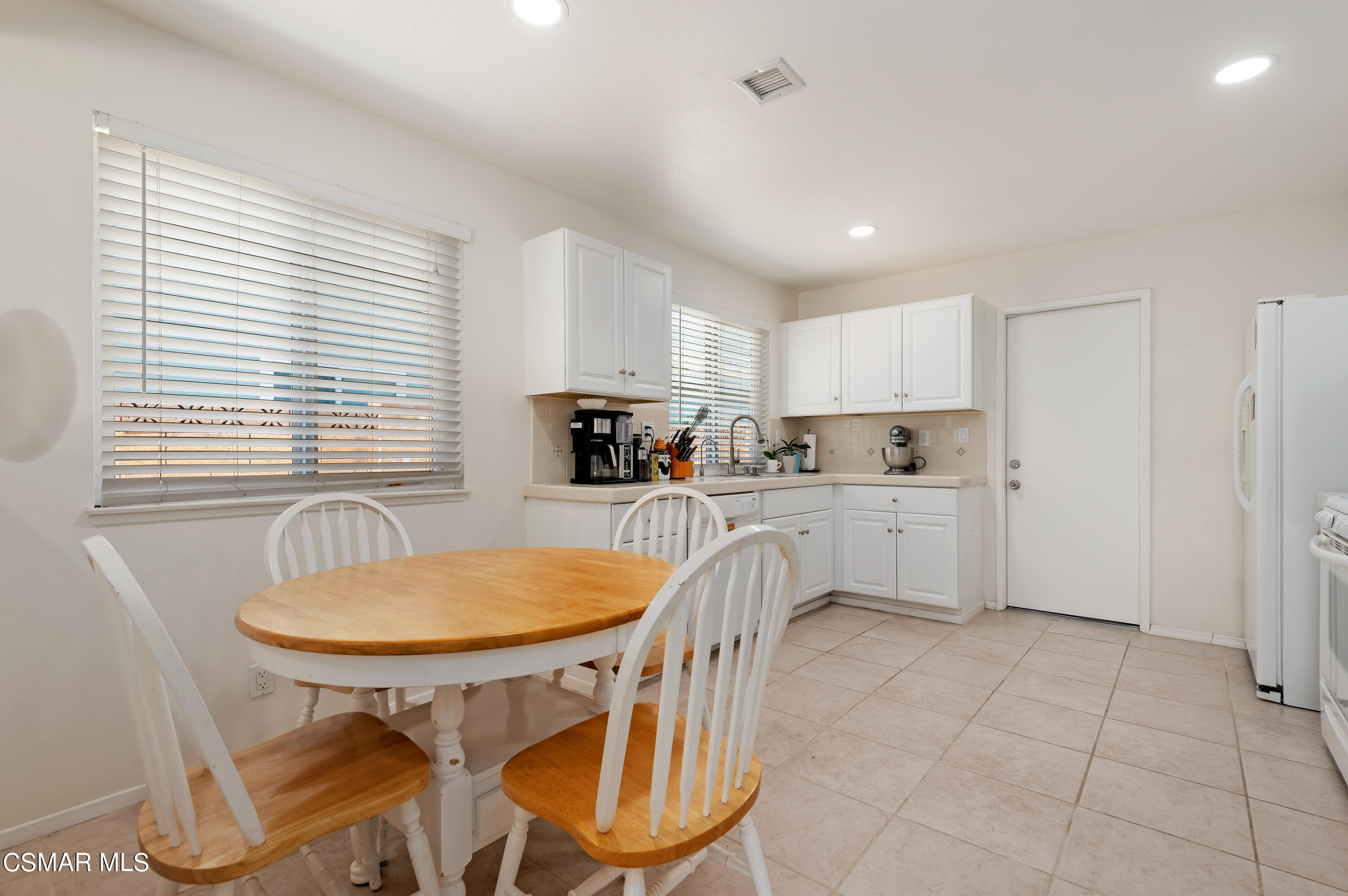 1714 Fitzgerald Road Simi Valley, CA 93065 - Photo 10 of 23 a kitchen with a sink a refrigerator and cabinets
