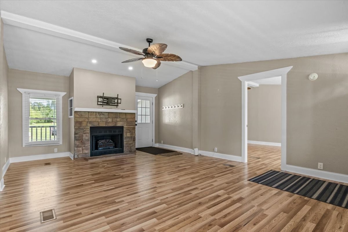 1112 Garners Creek Road Dickson, TN 37055 - Photo 7 of 57 a view of an empty room with wooden floor fireplace and a window