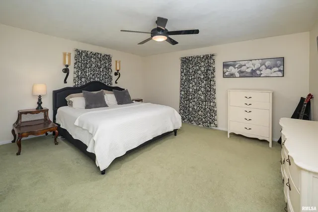 a bedroom with a bed dresser and a baby crib