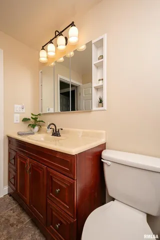 a bathroom with a toilet sink and mirror