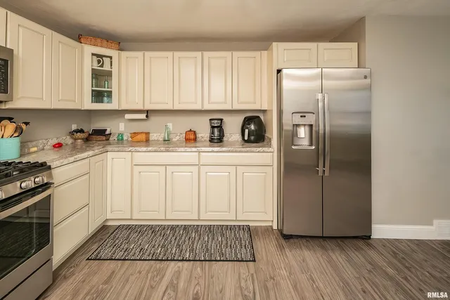 a kitchen with stainless steel appliances a refrigerator sink and cabinets