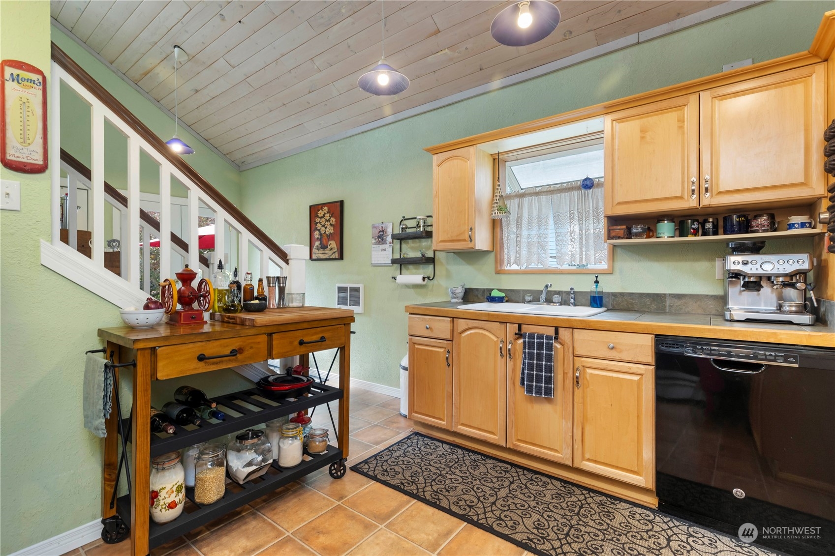 2812 19th Street Everett, WA 98201 - Photo 12 of 27 a open kitchen with stainless steel appliances granite countertop a sink dishwasher a stove and a microwave oven with cabinets