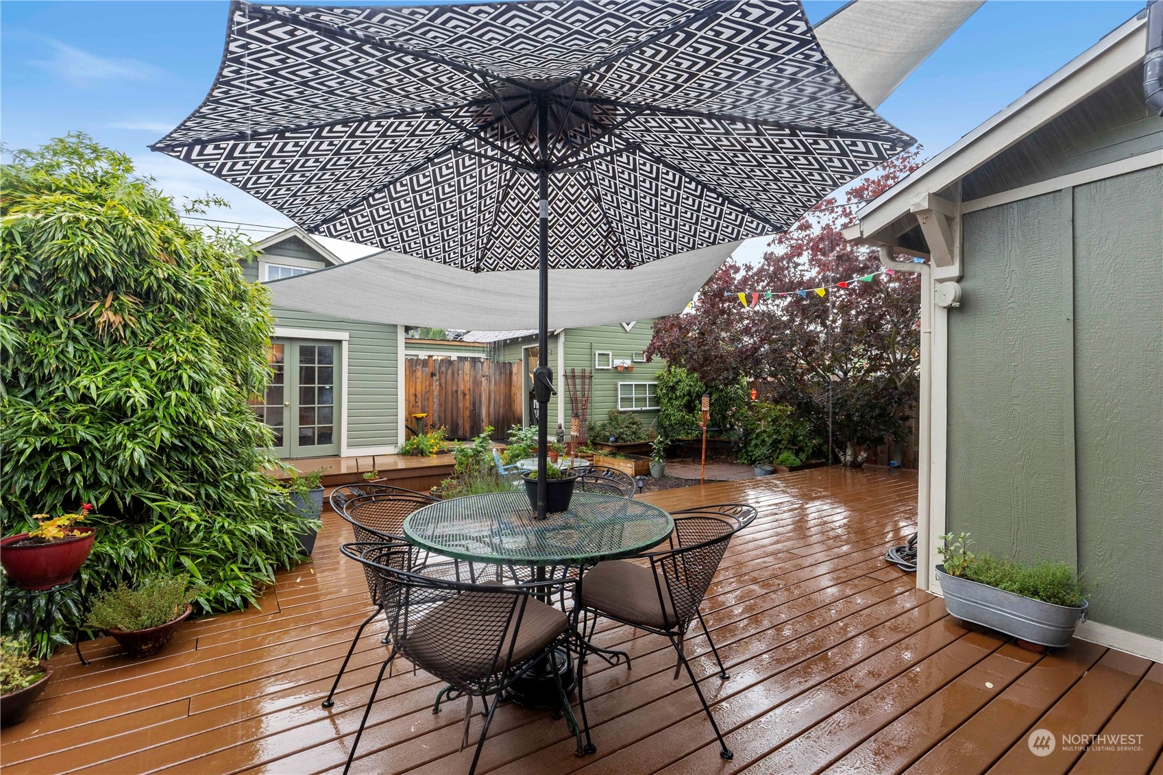 2812 19th Street Everett, WA 98201 - Photo 24 of 27 a patio with wooden floor a yard a table and chairs