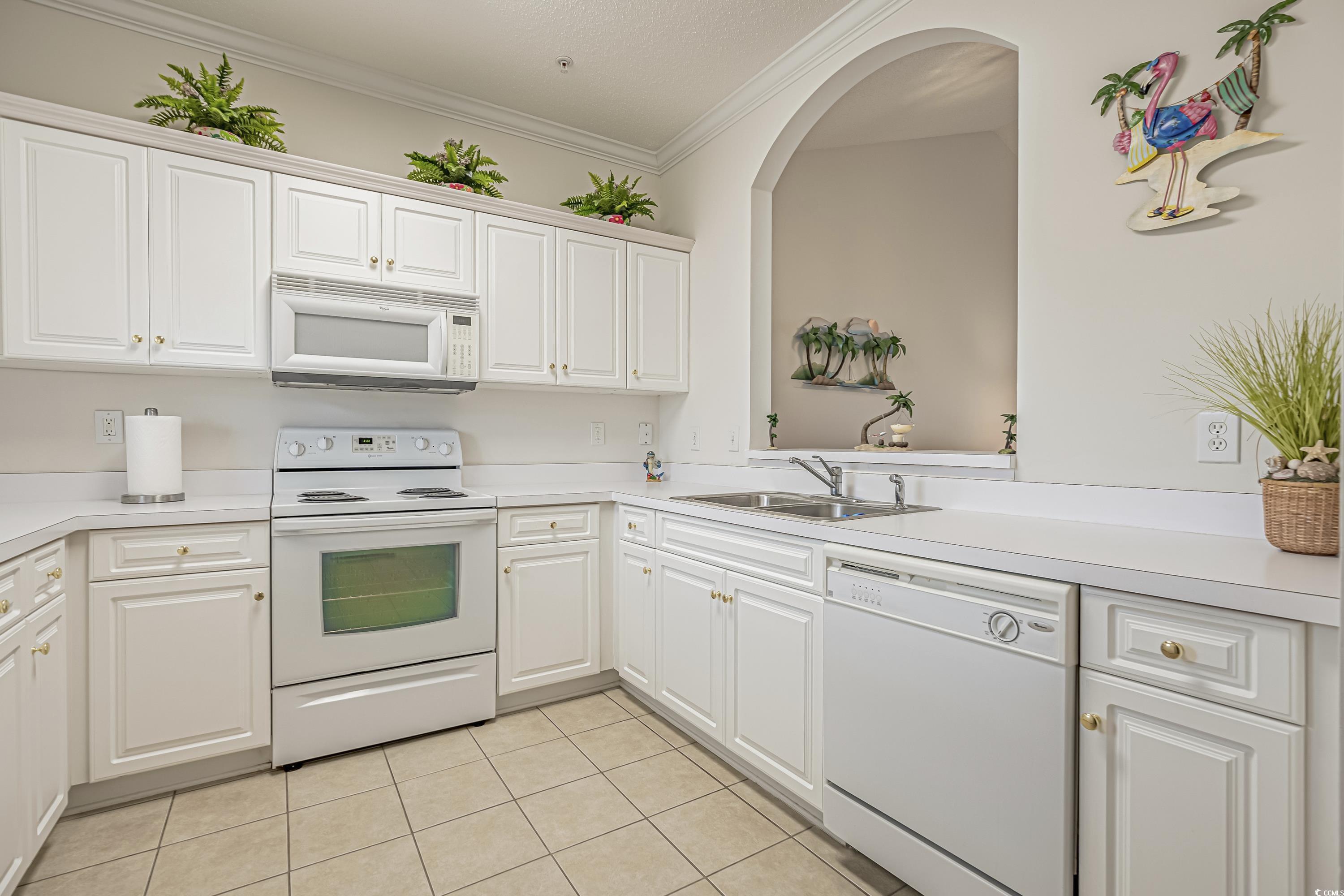 500 Wickham Drive, Unit HEATHERSTONE BUILDING 12 Myrtle Beach, SC 29579 - Photo 13 of 32 Kitchen featuring ornamental molding, white appliances, light countertops, light tile patterned floors, and white cabinetry