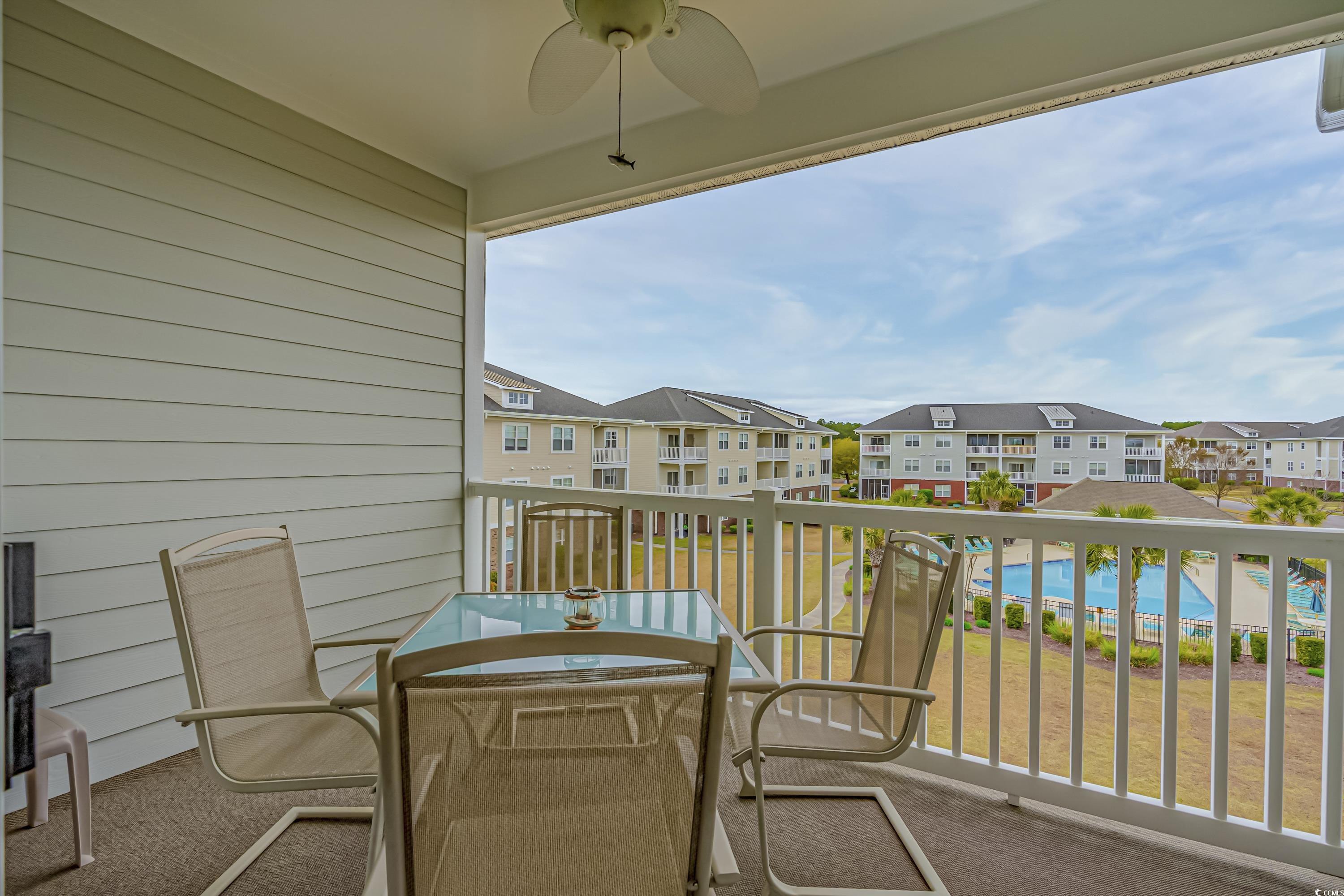 500 Wickham Drive, Unit HEATHERSTONE BUILDING 12 Myrtle Beach, SC 29579 - Photo 16 of 32 Balcony with view of pool area, ceiling fan, and outdoor dining area