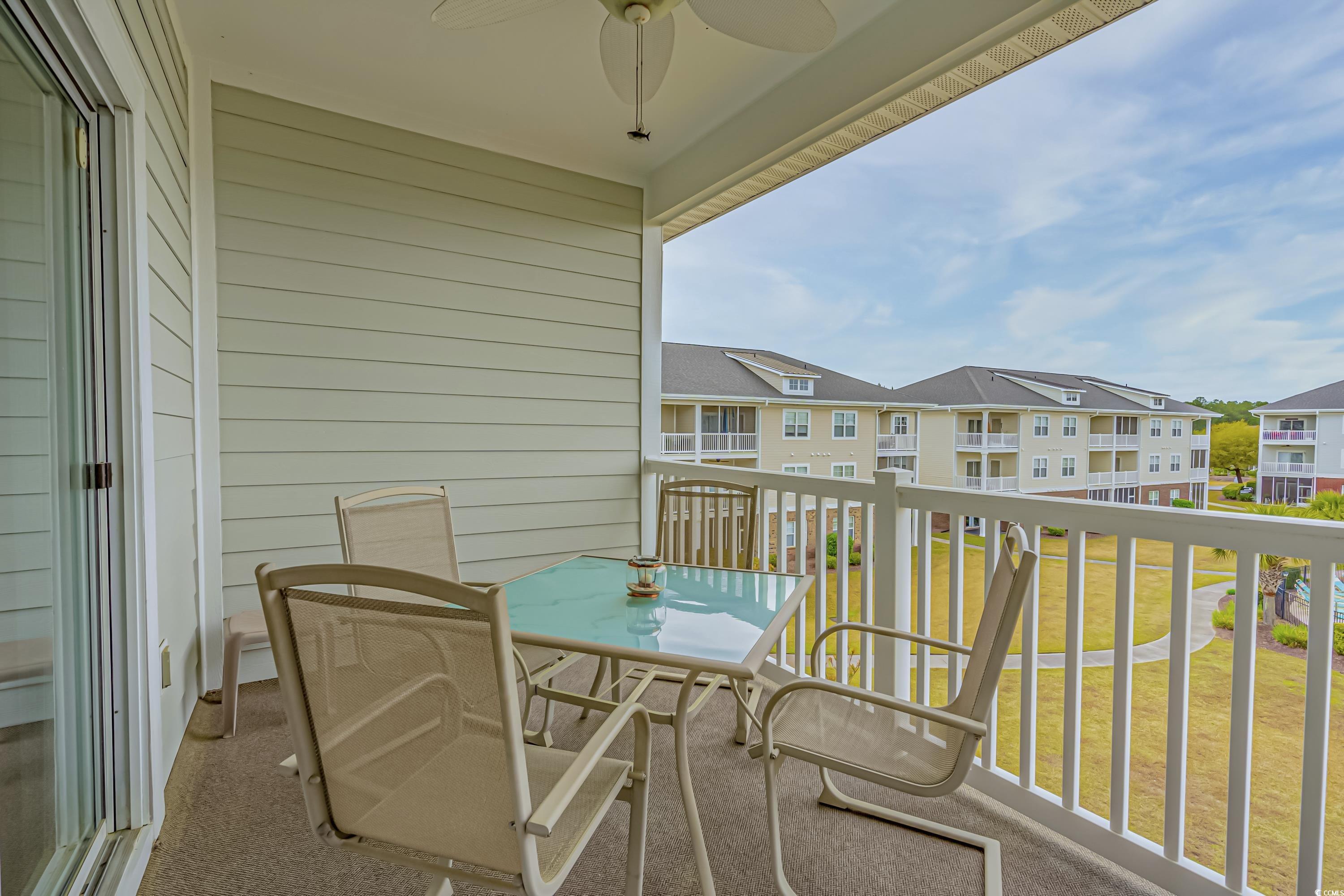 500 Wickham Drive, Unit HEATHERSTONE BUILDING 12 Myrtle Beach, SC 29579 - Photo 17 of 32 Balcony with ceiling fan and a sunroom