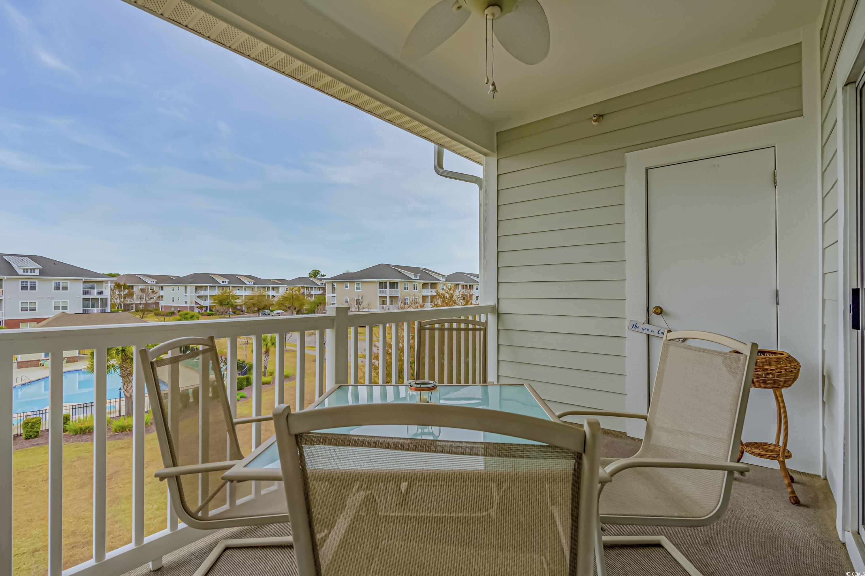 500 Wickham Drive, Unit HEATHERSTONE BUILDING 12 Myrtle Beach, SC 29579 - Photo 18 of 32 Balcony featuring a ceiling fan and outdoor dining space