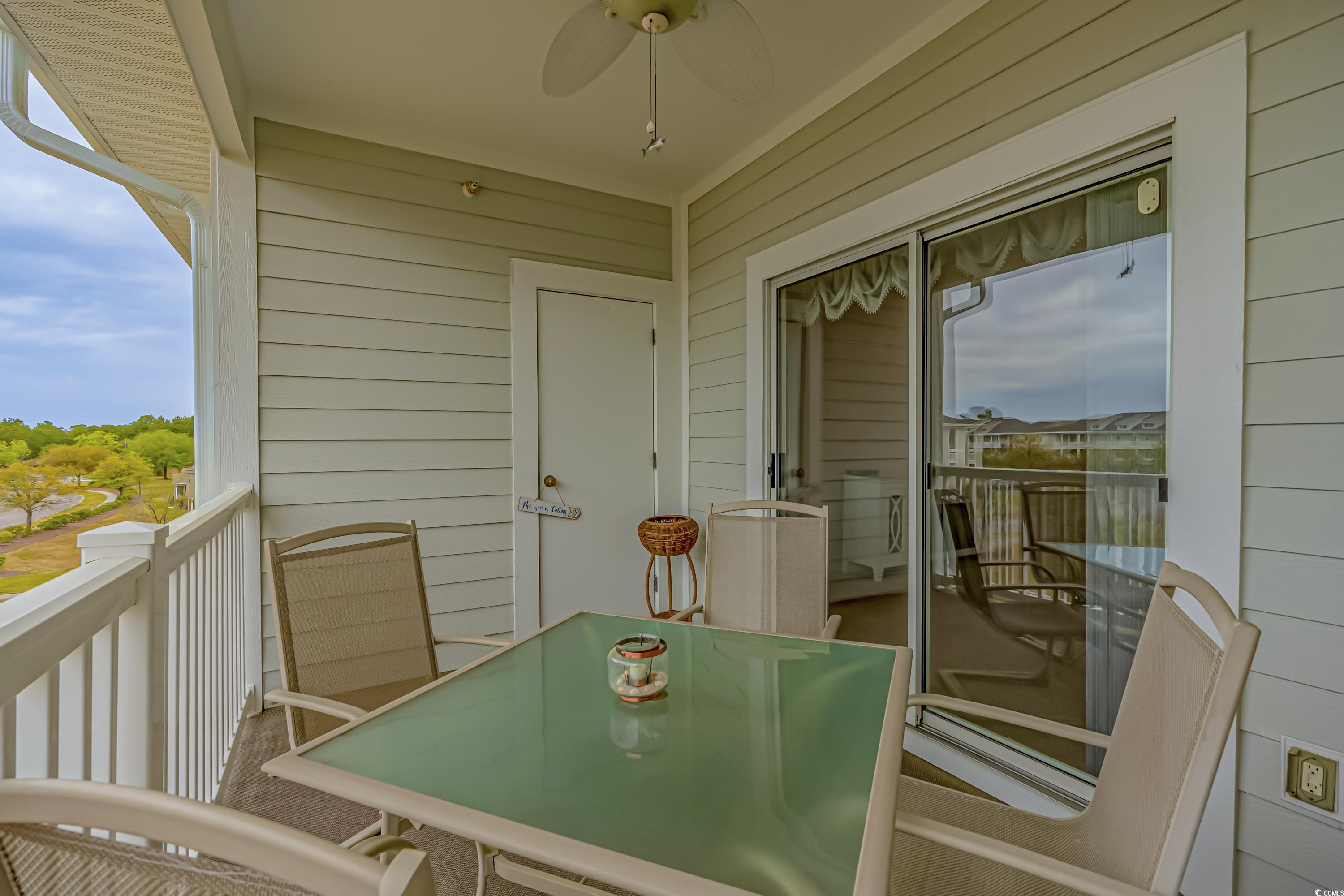 500 Wickham Drive, Unit HEATHERSTONE BUILDING 12 Myrtle Beach, SC 29579 - Photo 19 of 32 Balcony with a ceiling fan and outdoor dining space
