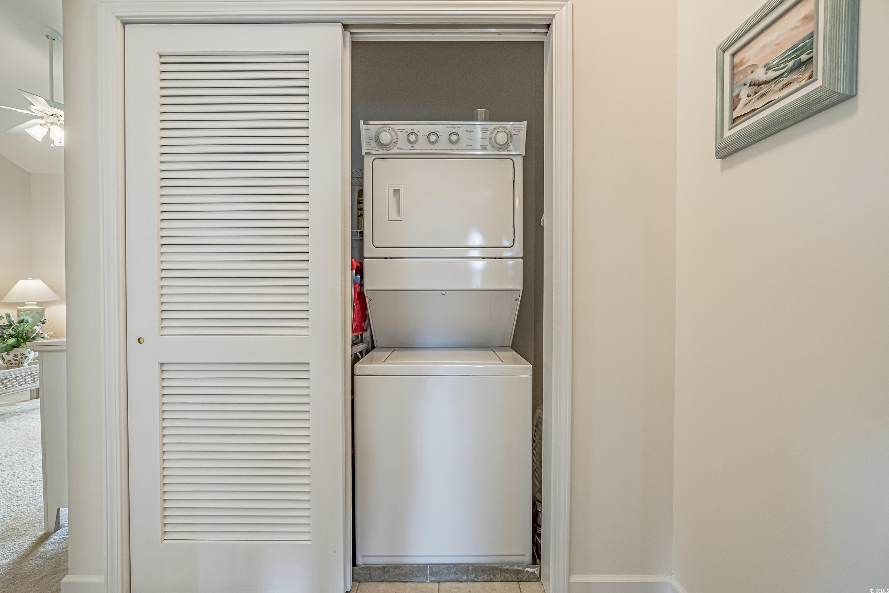 500 Wickham Drive, Unit HEATHERSTONE BUILDING 12 Myrtle Beach, SC 29579 - Photo 29 of 32 Laundry room featuring stacked washing machine and dryer and tile patterned flooring