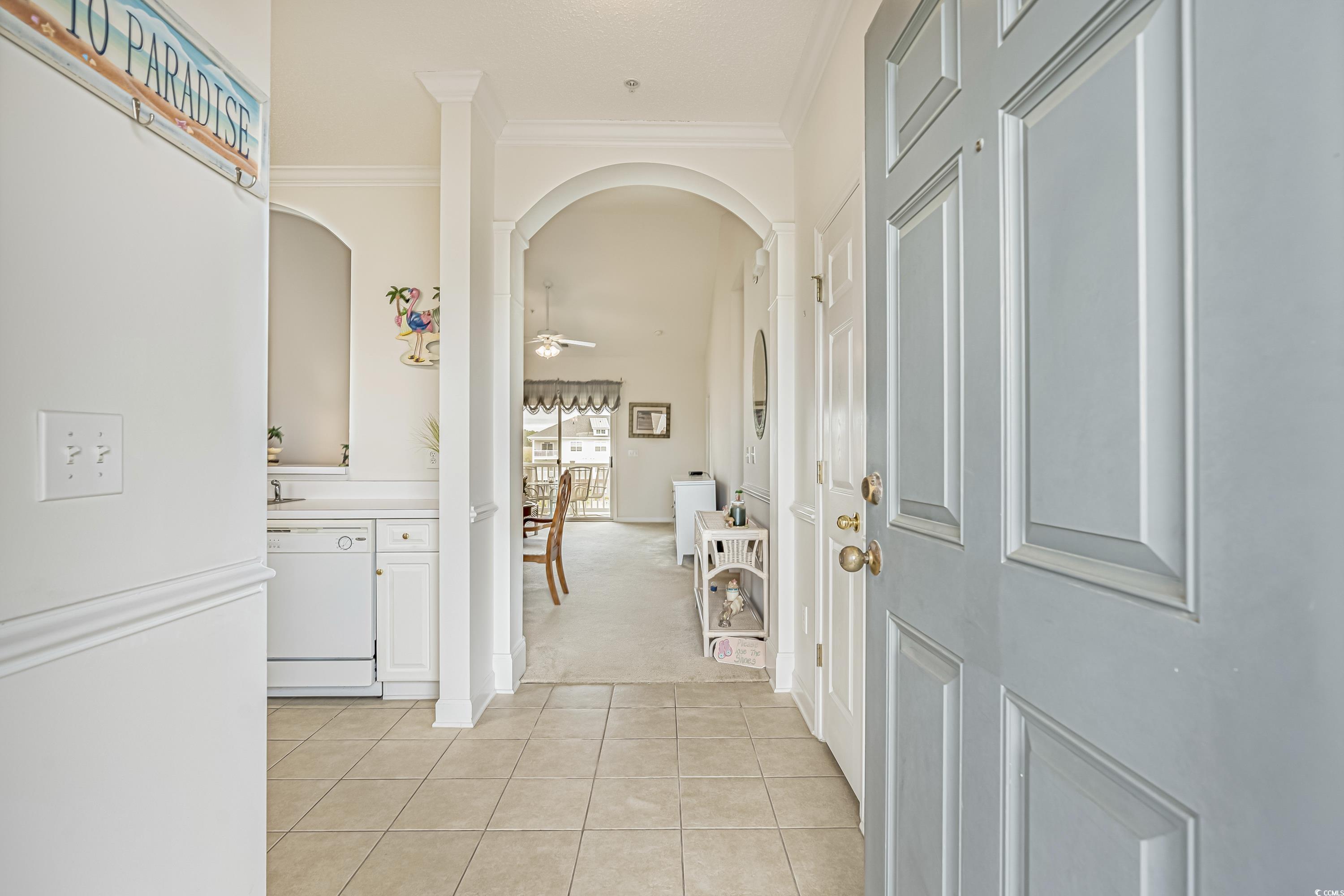 500 Wickham Drive, Unit HEATHERSTONE BUILDING 12 Myrtle Beach, SC 29579 - Photo 3 of 32 Foyer featuring arched walkways, light tile patterned flooring, light carpet, a ceiling fan, and ornamental molding