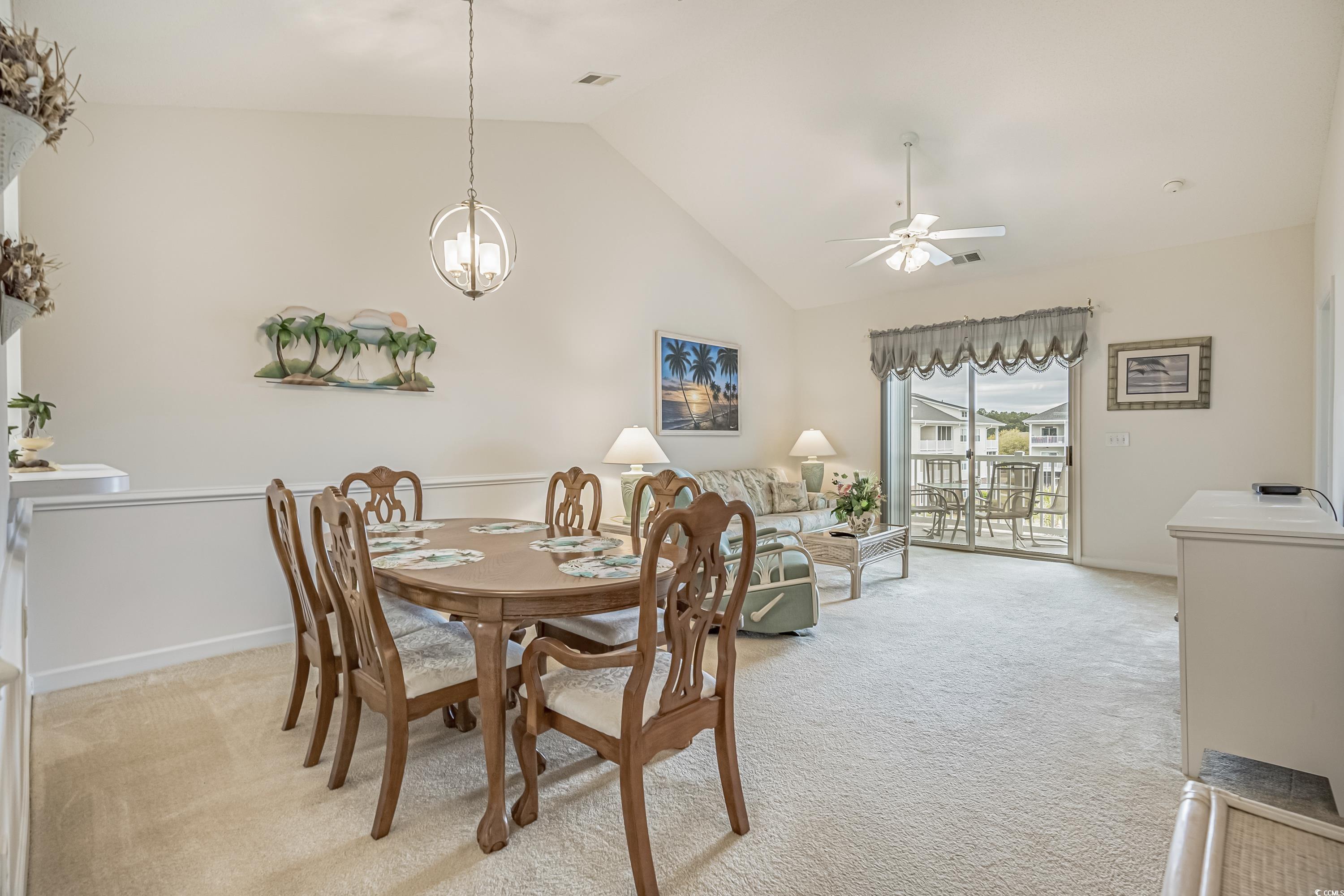 500 Wickham Drive, Unit HEATHERSTONE BUILDING 12 Myrtle Beach, SC 29579 - Photo 4 of 32 Dining room featuring light carpet, high vaulted ceiling, a ceiling fan, and a chandelier