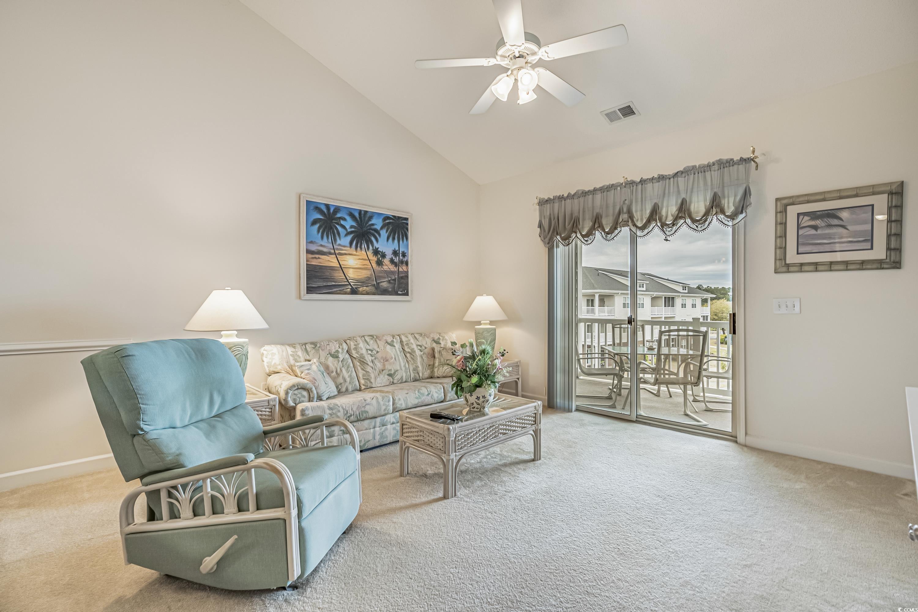 500 Wickham Drive, Unit HEATHERSTONE BUILDING 12 Myrtle Beach, SC 29579 - Photo 5 of 32 Carpeted living area with ceiling fan and high vaulted ceiling