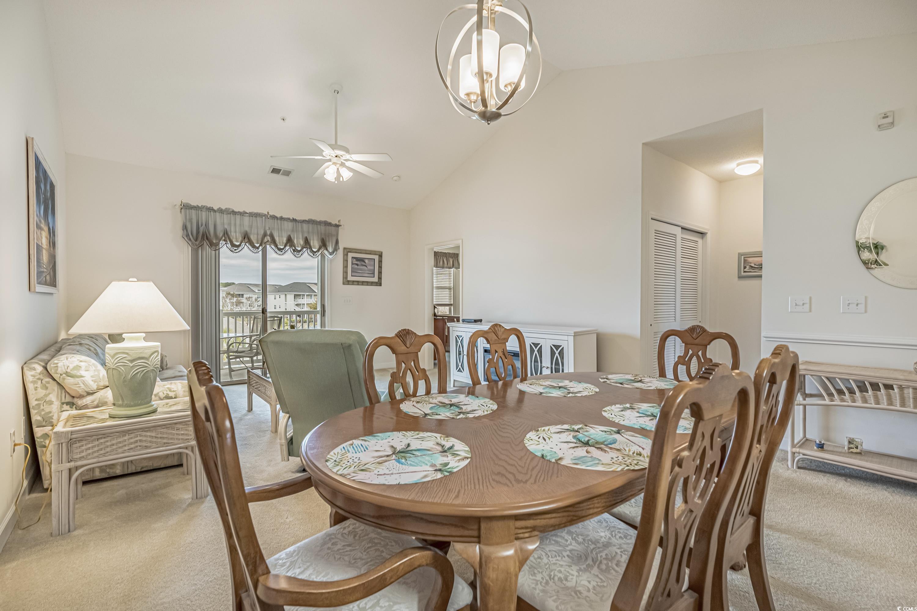 500 Wickham Drive, Unit HEATHERSTONE BUILDING 12 Myrtle Beach, SC 29579 - Photo 10 of 32 Carpeted dining area featuring lofted ceiling, a chandelier, and ceiling fan