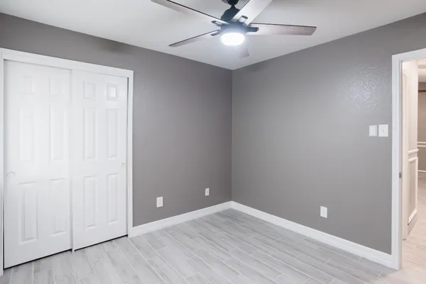 a bathroom with a granite countertop toilet a sink and a mirror
