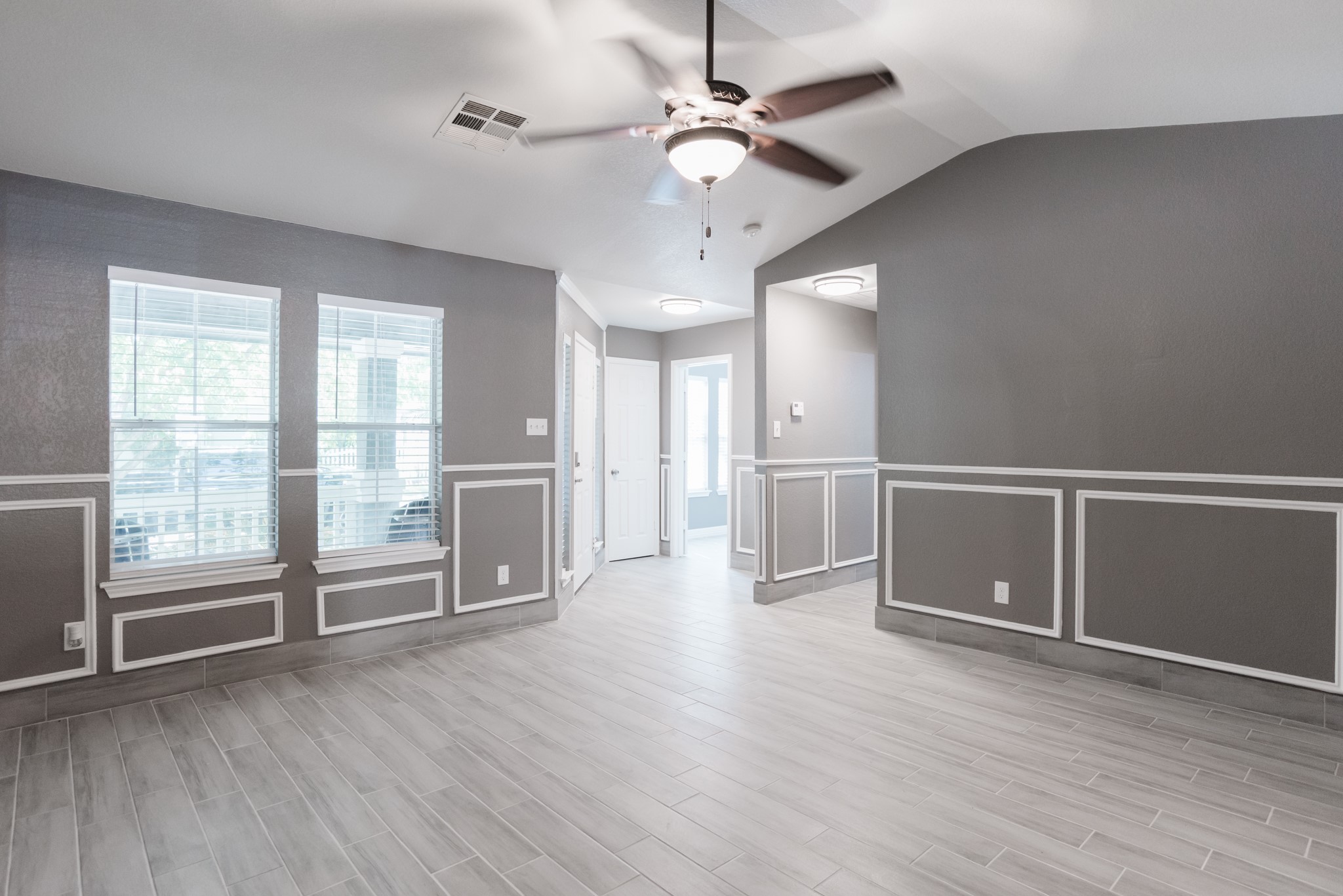 692 Scheel Kyle, TX 78640 - Photo 12 of 40 a view of an empty room with a window and wooden floor