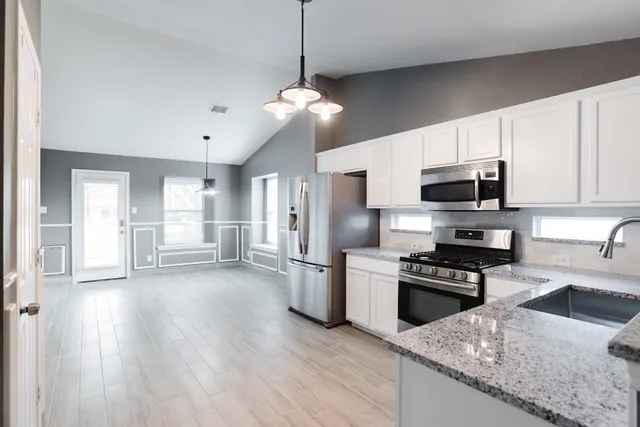 a kitchen with a stove microwave and refrigerator