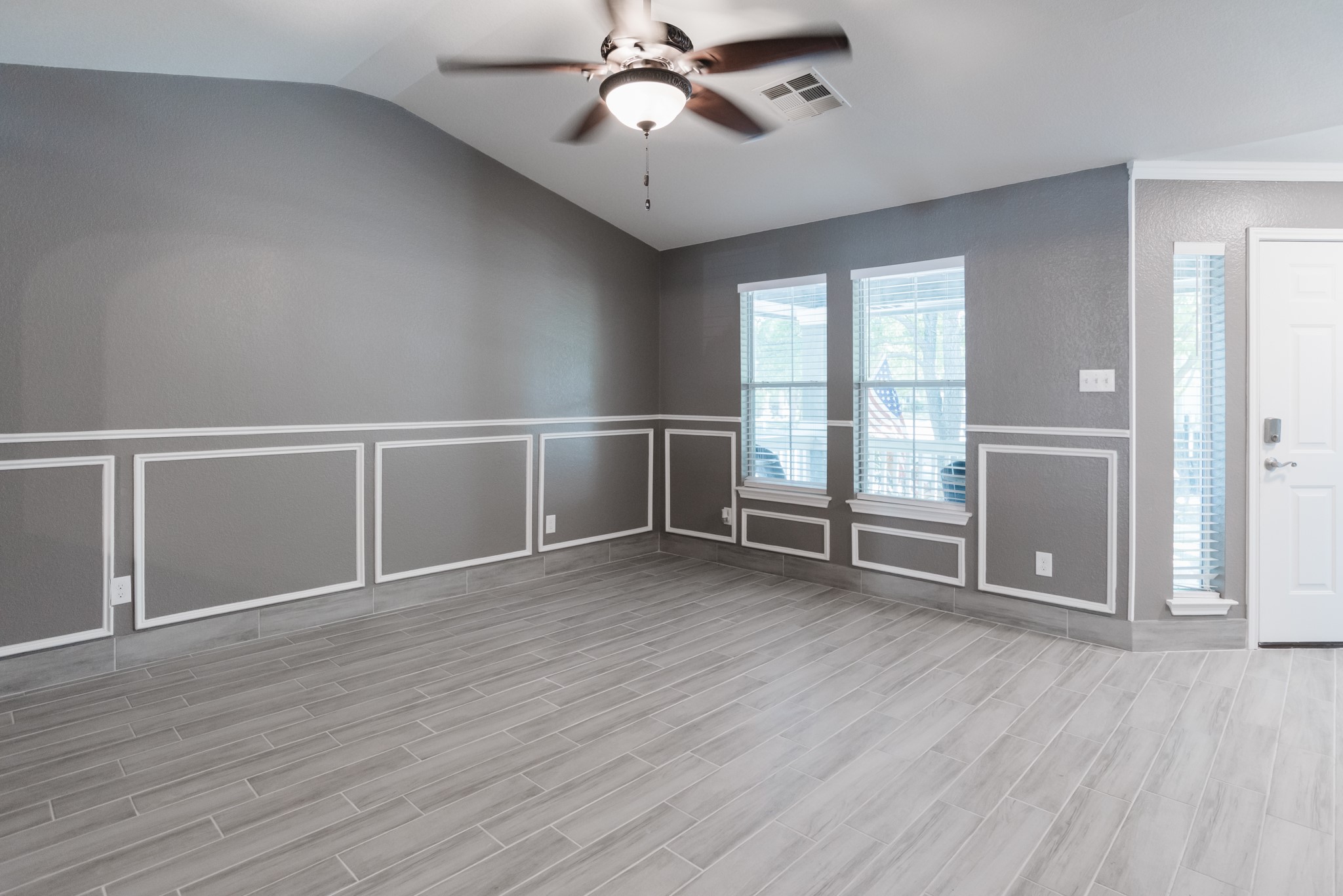 692 Scheel Kyle, TX 78640 - Photo 15 of 40 an empty room with wooden floor fan and windows