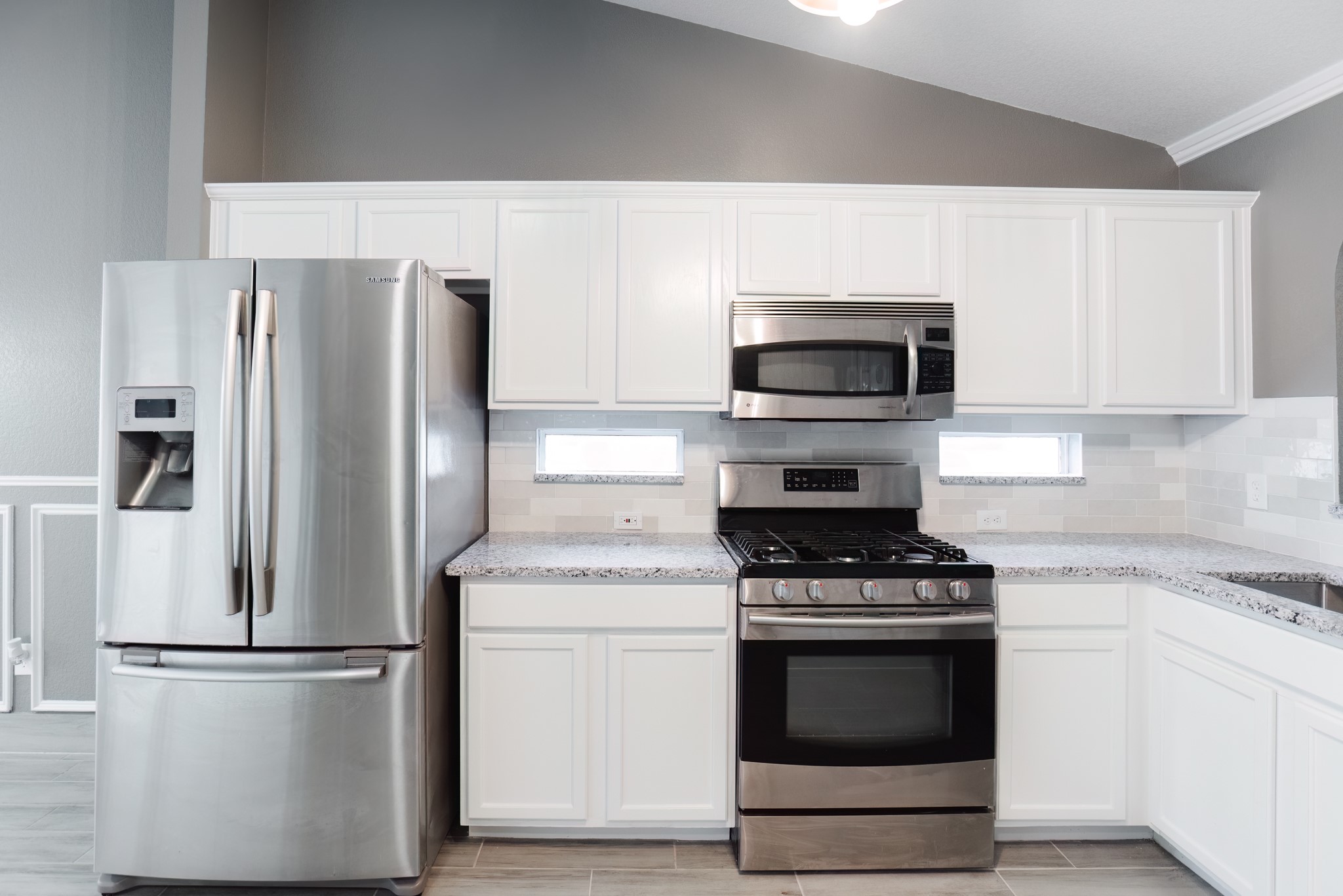 692 Scheel Kyle, TX 78640 - Photo 18 of 40 a kitchen with a stove microwave and refrigerator