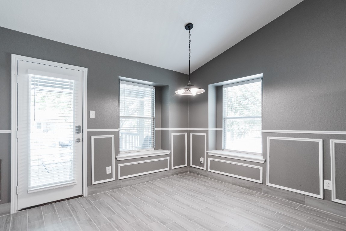 692 Scheel Kyle, TX 78640 - Photo 21 of 34 a view of an empty room with a window and wooden floor