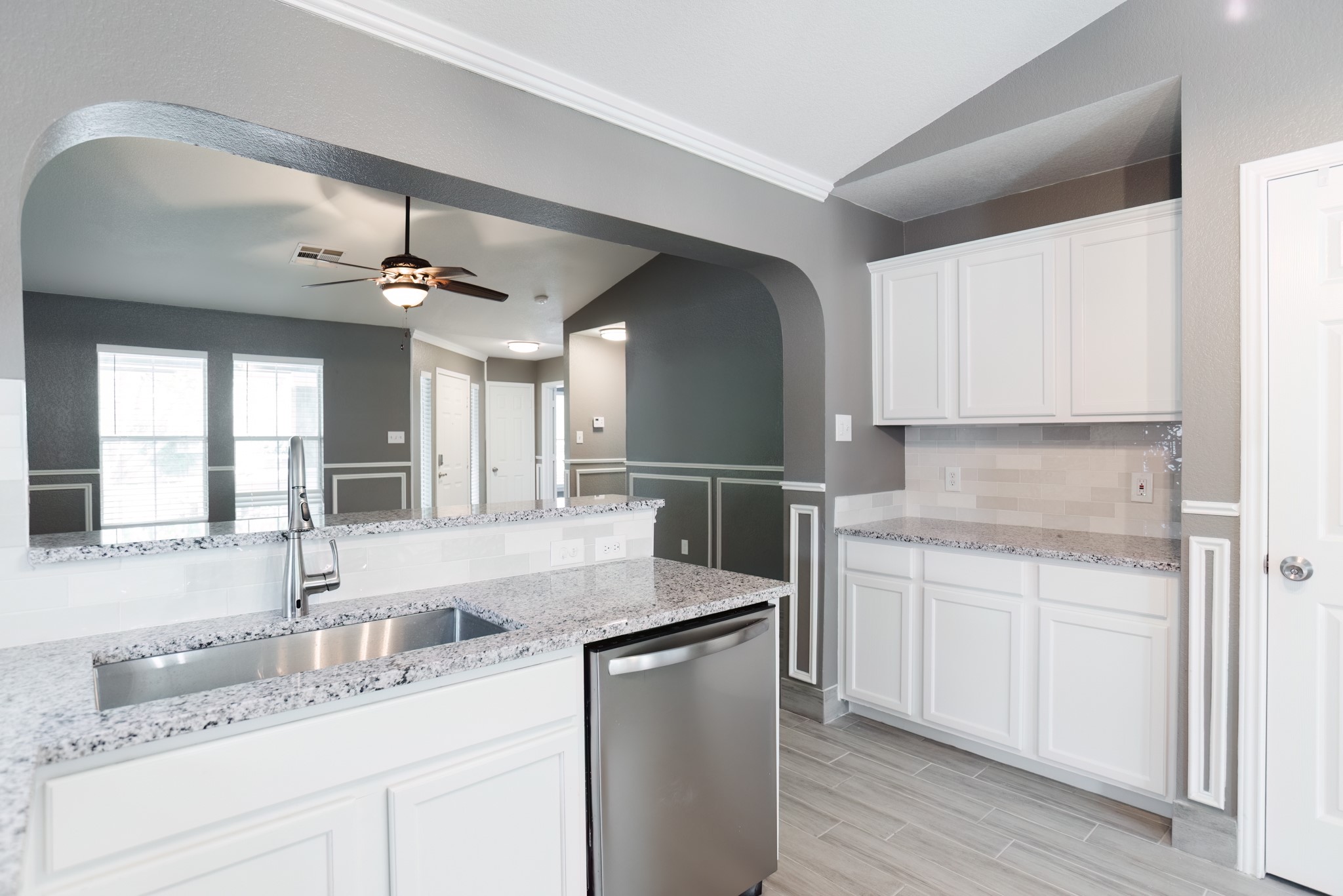 692 Scheel Kyle, TX 78640 - Photo 21 of 40 a kitchen with a sink cabinets stainless steel appliances and a window