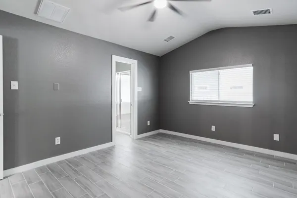 a view of empty room with wooden floor