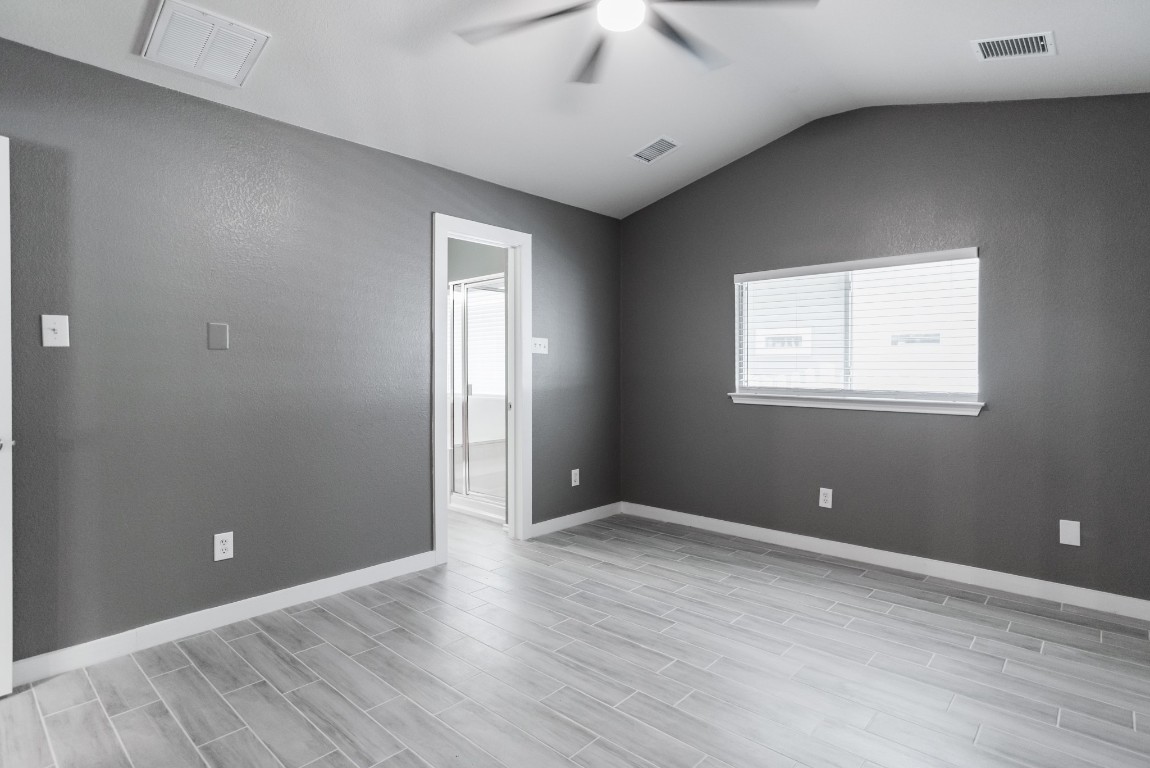692 Scheel Kyle, TX 78640 - Photo 23 of 34 a view of an empty room with wooden floor and a window