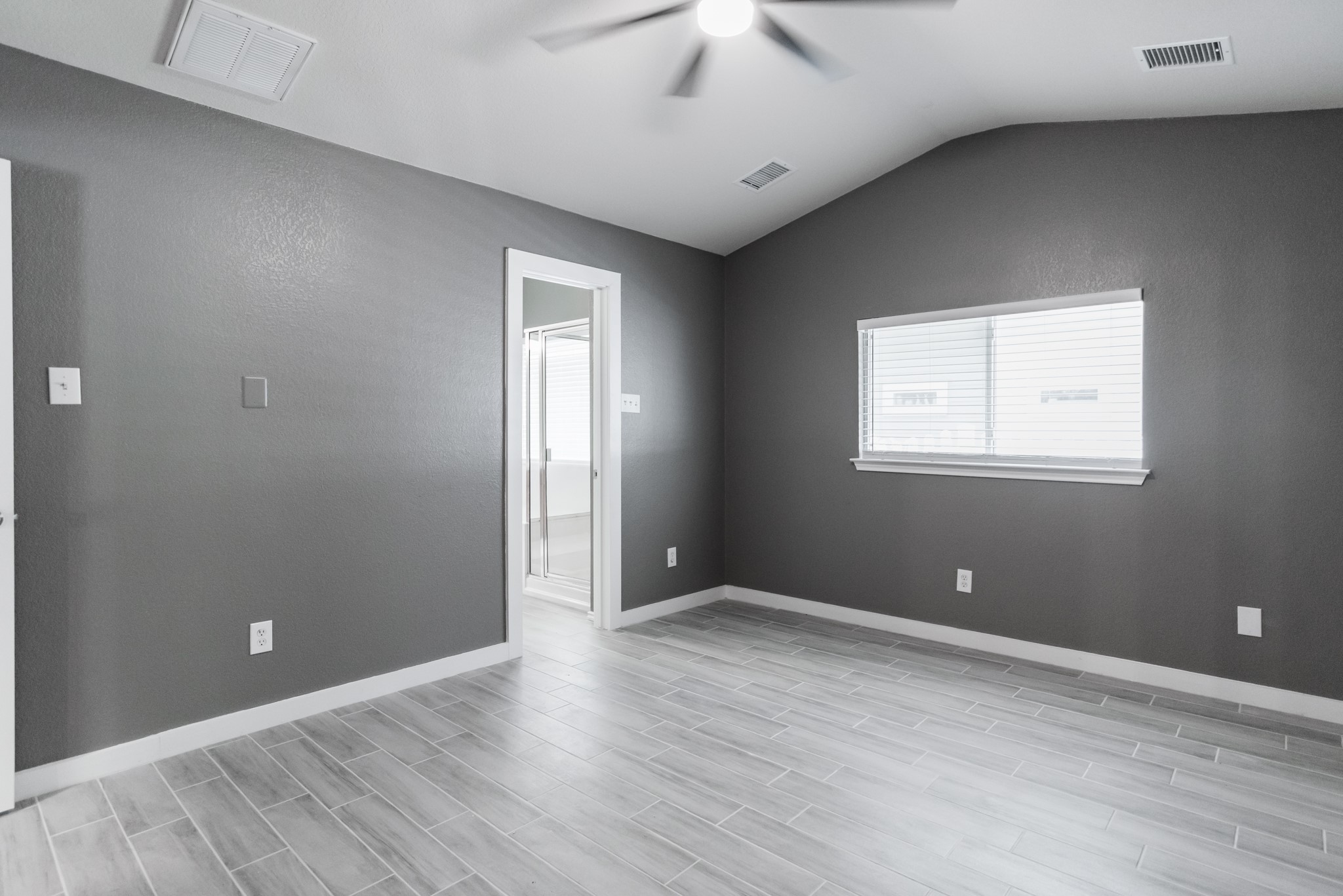 692 Scheel Kyle, TX 78640 - Photo 27 of 40 a view of an empty room with wooden floor and a window