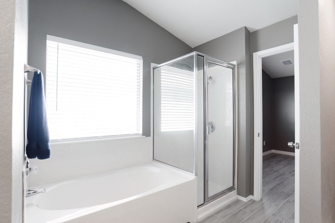 692 Scheel Kyle, TX 78640 - Photo 27 of 34 a bathroom with a bathtub and a shower