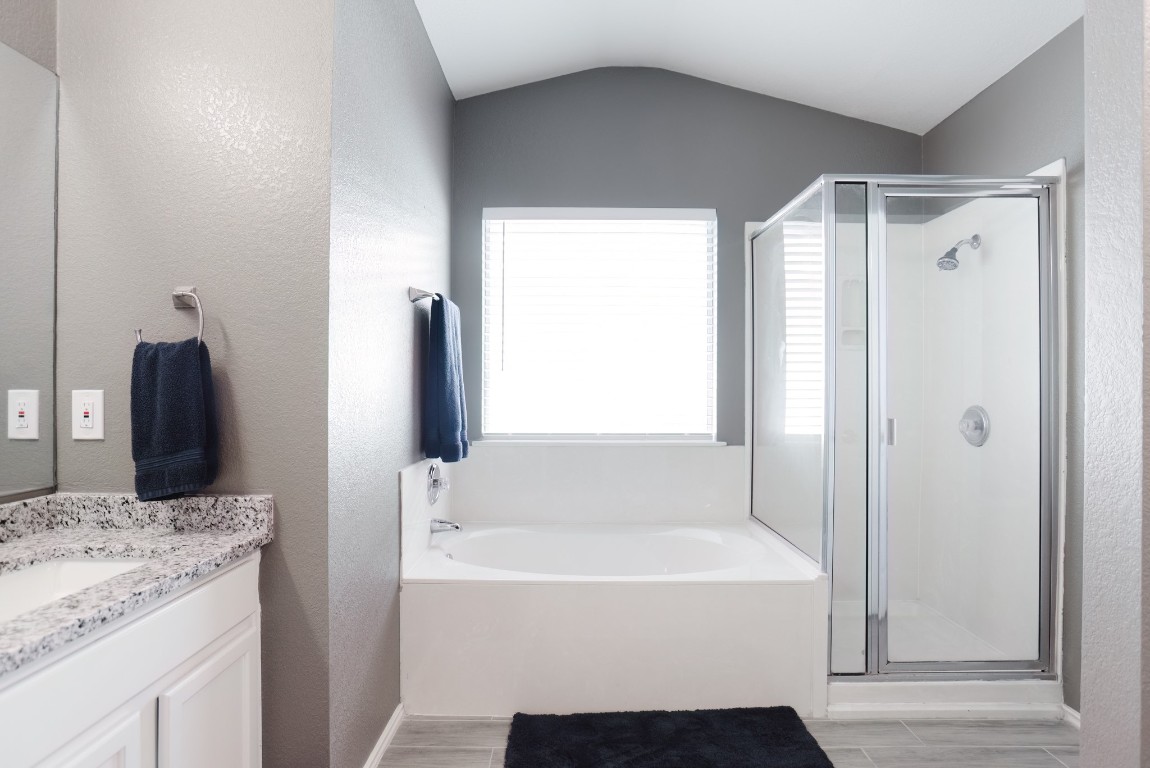 692 Scheel Kyle, TX 78640 - Photo 28 of 34 a bathroom with a granite countertop sink and a mirror
