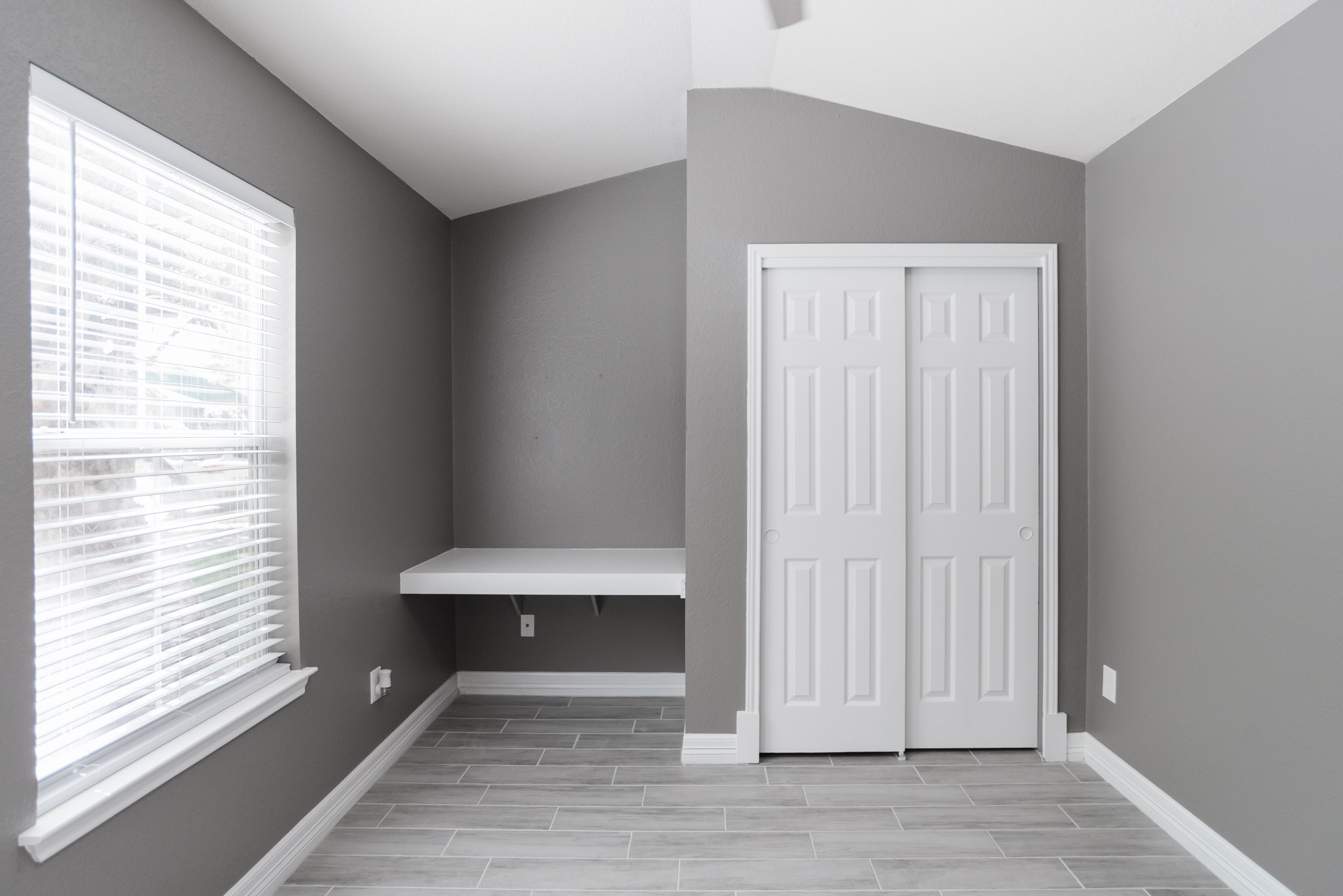 692 Scheel Kyle, TX 78640 - Photo 7 of 40 a view of an empty room with wooden floor and a window