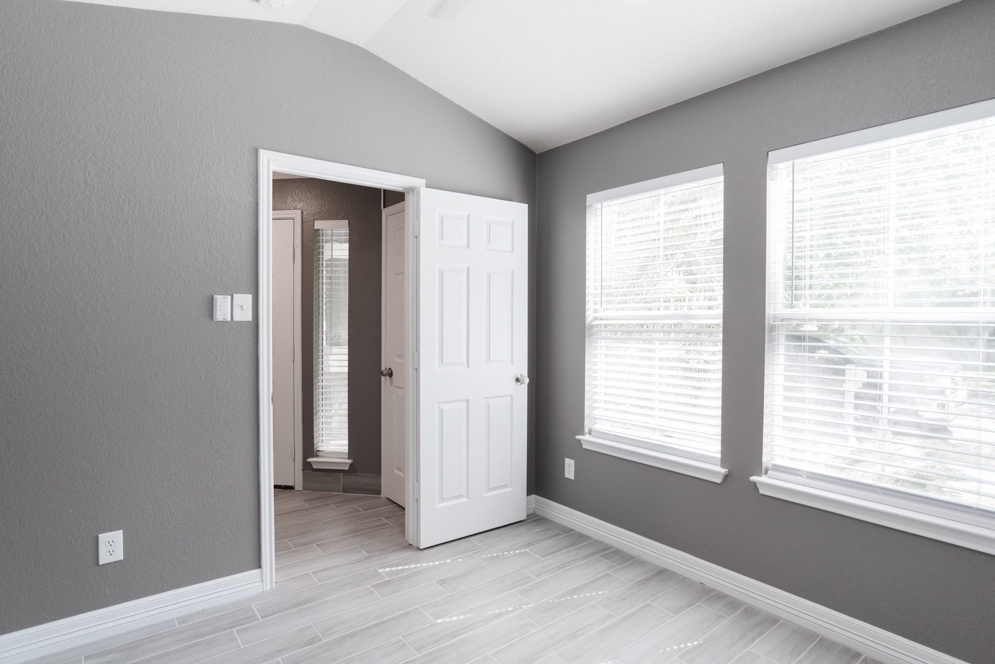 692 Scheel Kyle, TX 78640 - Photo 9 of 40 a view of an empty room with wooden floor and a window