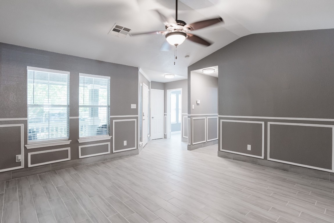 692 Scheel Kyle, TX 78640 - Photo 10 of 34 a view of an empty room with a window and wooden floor