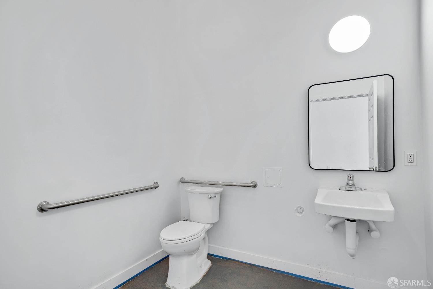 1644 Taraval Street San Francisco, CA 94116 - Photo 8 of 18 a bathroom with a toilet sink and mirror