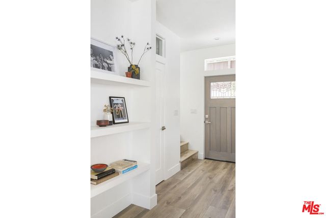 a bedroom with a large bed and a potted plant