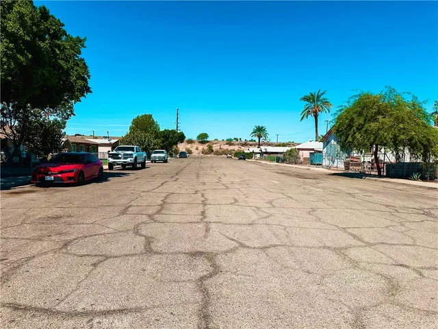 a view of car parked on the sidewalk