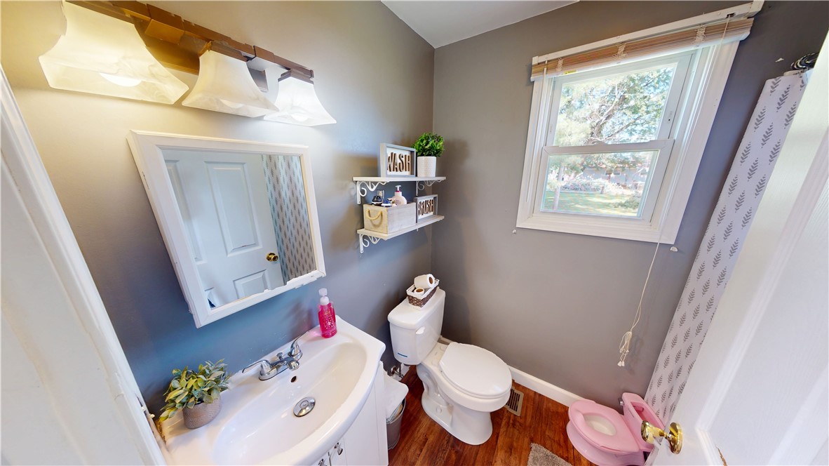 8 Chestnut Street Danville, IL 61832 - Photo 17 of 19 a white toilet sitting next to a bathroom sink and a tub